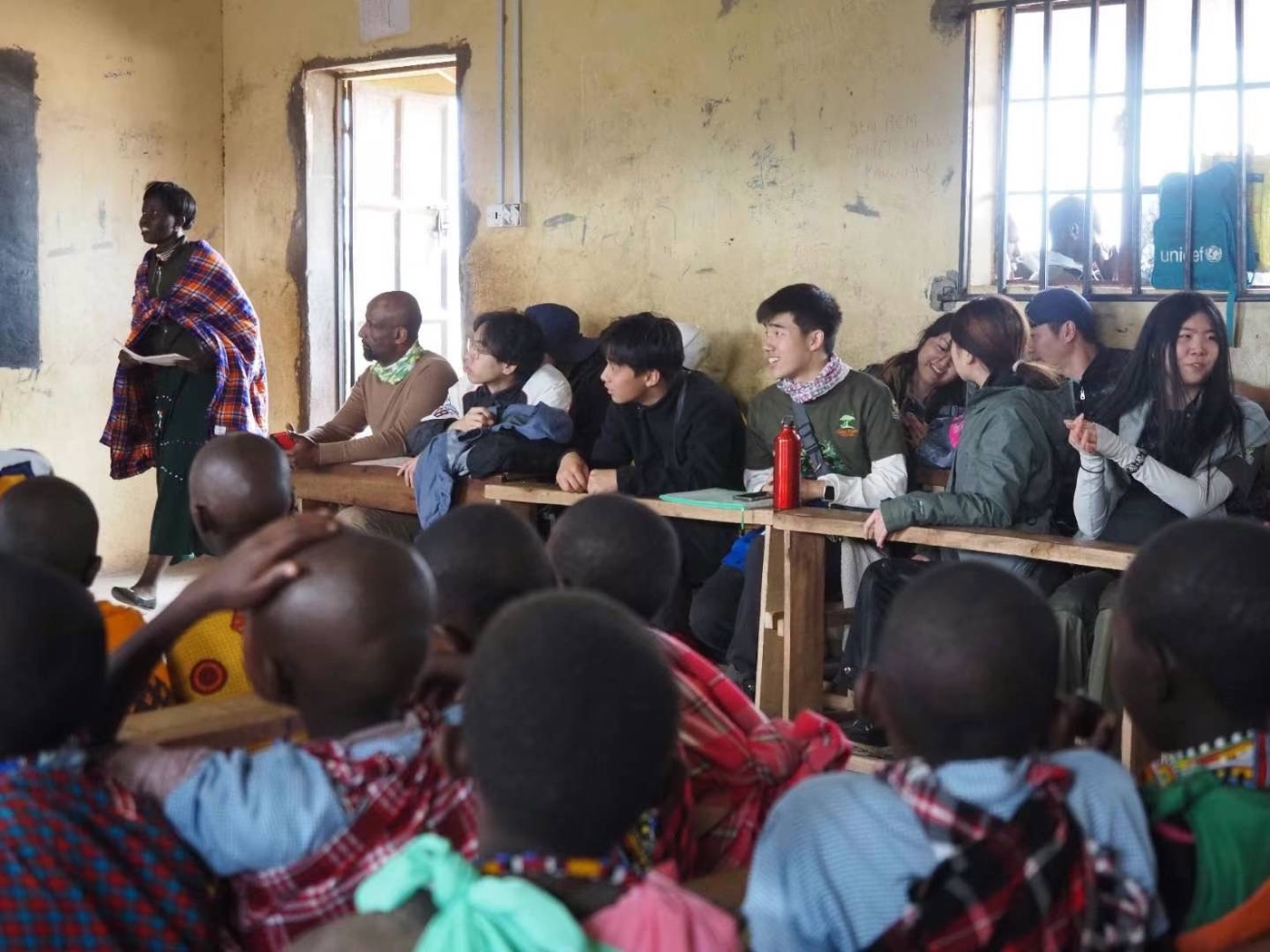 HWF mentors visiting a Maasai community classroom — the community context for the Lion Scholarship Initiative