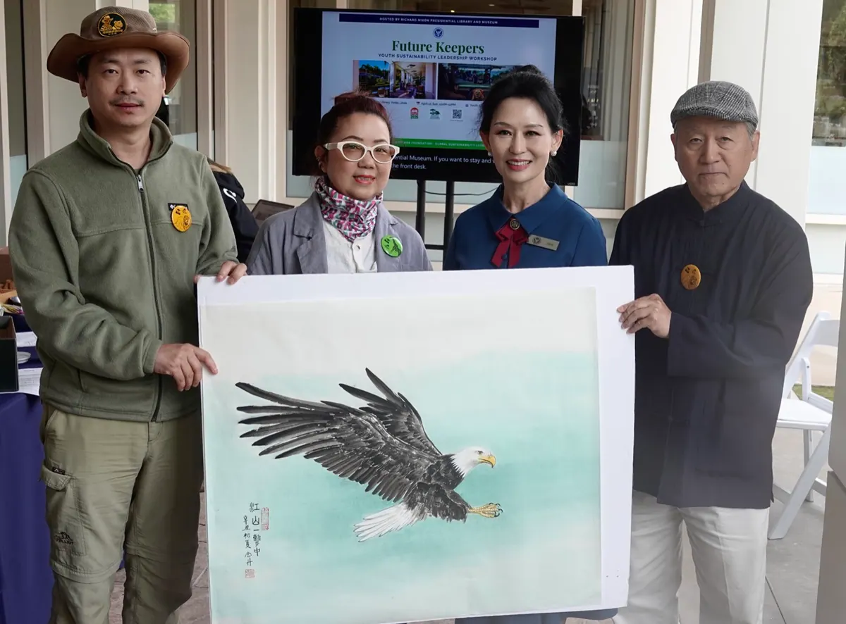 Master He Niandan presents a bald eagle painting to the Nixon Library through HWF — honoring Nixon's role in bald eagle recovery